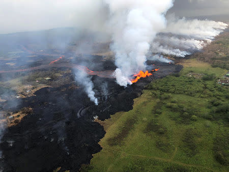 Aerial view of erupting fissure 22 and lava channels flowing southward from the fissure is seen from the air during an early morning overflight during ongoing eruptions of the Kilauea Volcano in Hawaii, U.S. May 21, 2018. Courtesy Volcano Helicopters/USGS/Handout via REUTERS