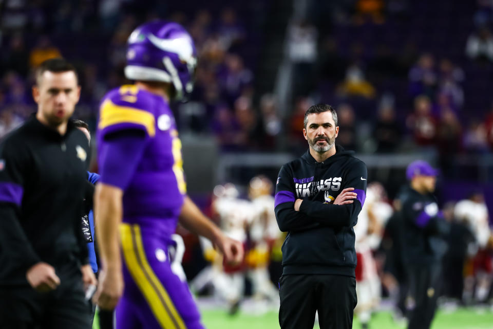 Oct 24, 2019; Minneapolis, MN, USA; Minnesota Vikings quarterback Kirk Cousins (8) participates in warm ups while offensive coordinator Kevin Stefanski looks on before the start of a game against the Washington Redskins at U.S. Bank Stadium. Mandatory Credit: David Berding-USA TODAY Sports