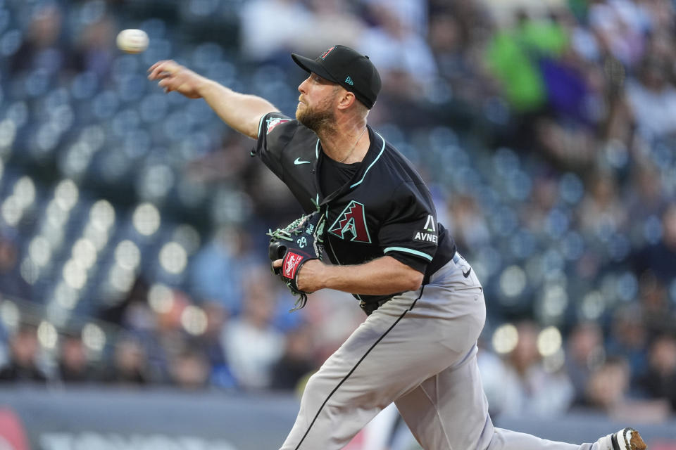 Arizona Diamondbacks starting pitcher Merrill Kelly works against the Colorado Rockies in the first inning of a baseball game Tuesday, April 9, 2024, in Denver. (AP Photo/David Zalubowski)