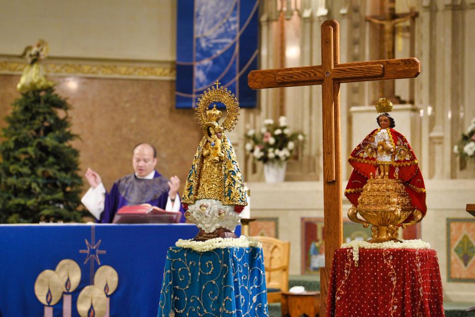 The Rev. Oliver D. Nilo leads Mass for Filipino congregants with the Pilgrim Cross, a replica of the cross planted in the Philippines 500 years ago, at St. John the Evangelist Church in Bergenfield on Sunday Dec. 19, 2021. This cross will travel from church to church across the diocese.