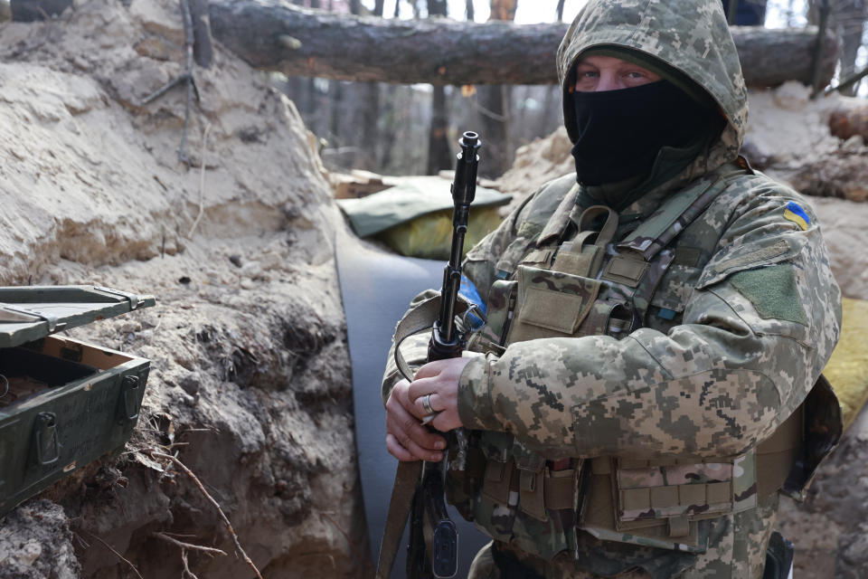 A Ukrainian serviceman guards his position near Brovary, north of Kyiv, Ukraine, Thursday, March 17, 2022. (AP Photo/Serhii Nuzhnenko)
