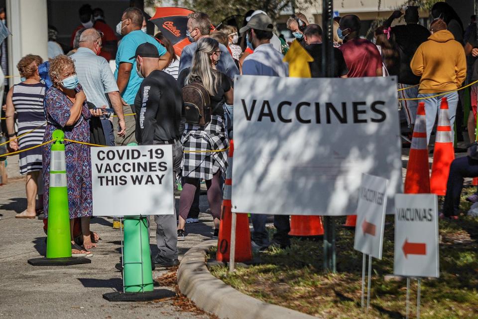 Hundreds of people queue in crowd corrals at the Mid County Service Center at 3680 Lake Worth Road  for COVID-19 testing and vaccinations in 2021.