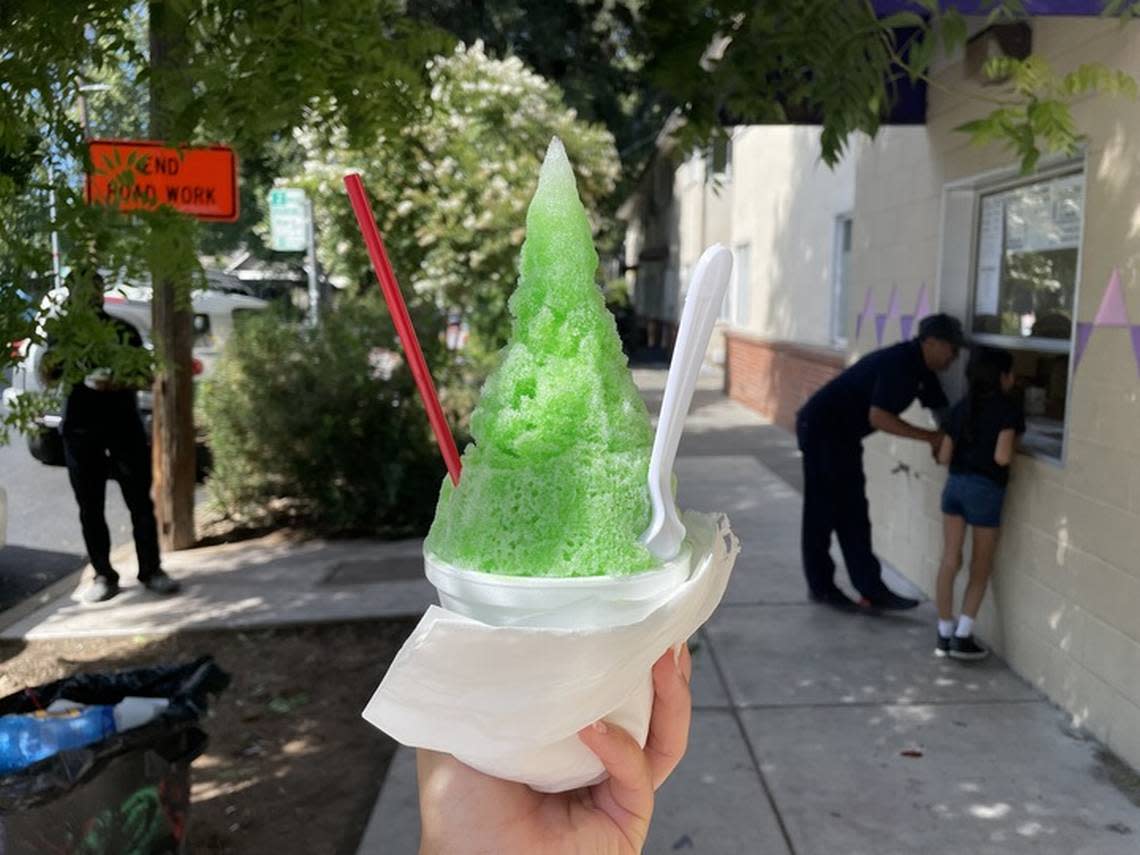 Service journalism reporter Brianna Taylor visits Osaka-Ya at 2215 10th St., Sacramento on July 24, 2023, with $25. The $5 snowcone is a small-sized cup of shaved ice with sour-apple-flavored syrup.