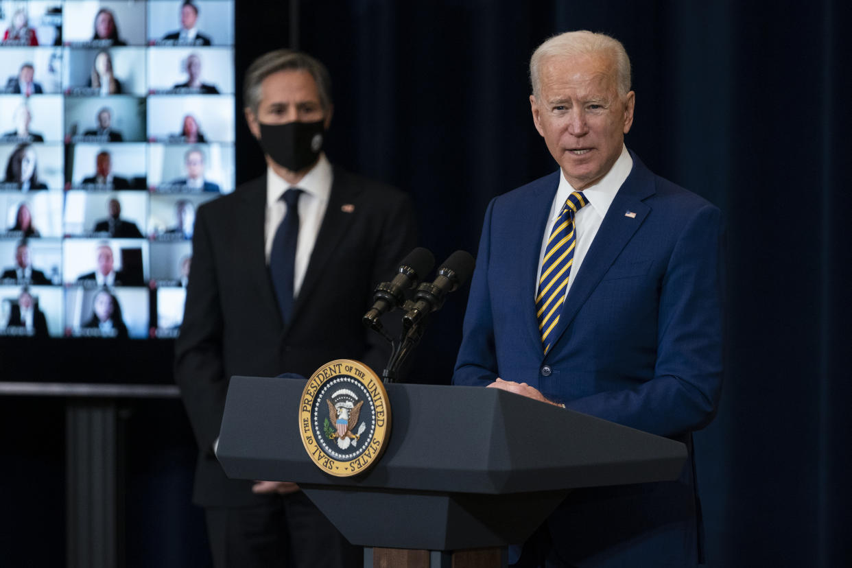 Secretary of State Antony Blinken listens as President Joe Biden delivers remarks to State Department staff, Thursday, Feb. 4, 2021, in Washington. (AP Photo/Evan Vucci)