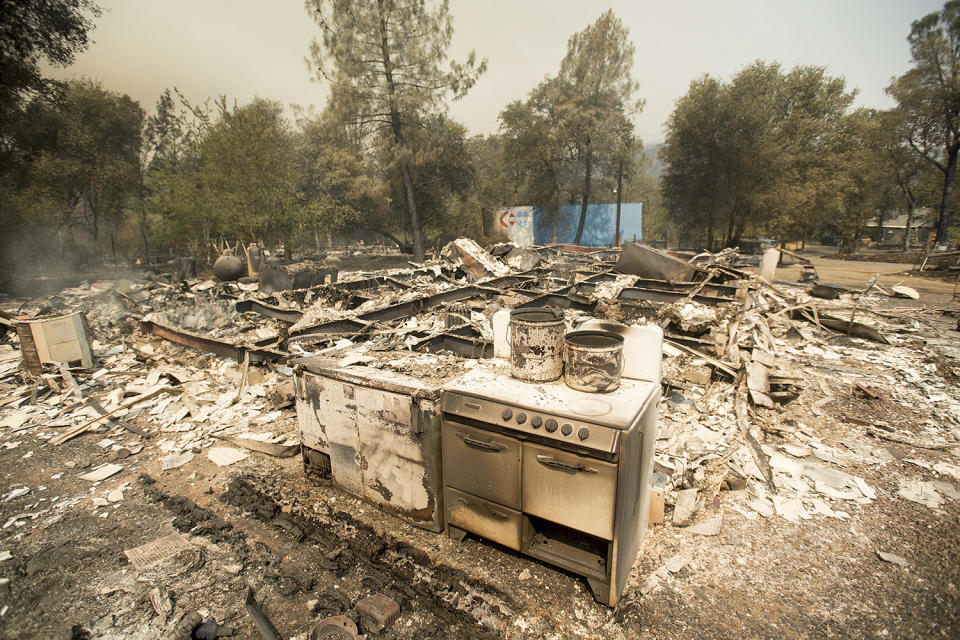 <p>A stove stands in front of a structure leveled by a wildfire near Oroville, Calif., on Saturday, July 8, 2017. Residents were ordered to evacuate from several roads in the rural area as flames climbed tall trees. (AP Photo/Noah Berger) </p>