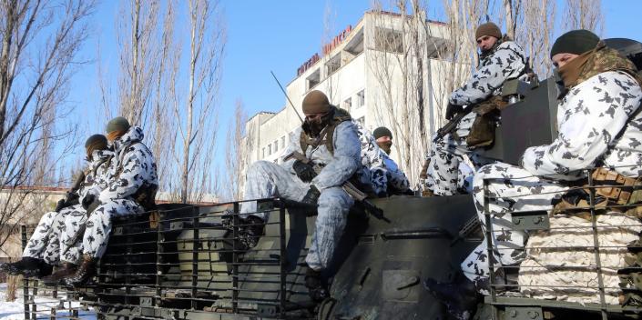 Soldiers sit inside the Chernobyl Exclusion Zone