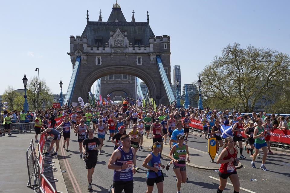 Runners pass the Tower of London during the 2018 marathon (Getty)