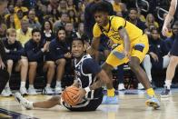 Butler's Jayden Taylor looks to pass with Marquette's Olivier-Maxence Prosper defending during the first half of an NCAA college basketball game Saturday, Feb. 4, 2023, in Milwaukee. (AP Photo/Morry Gash)