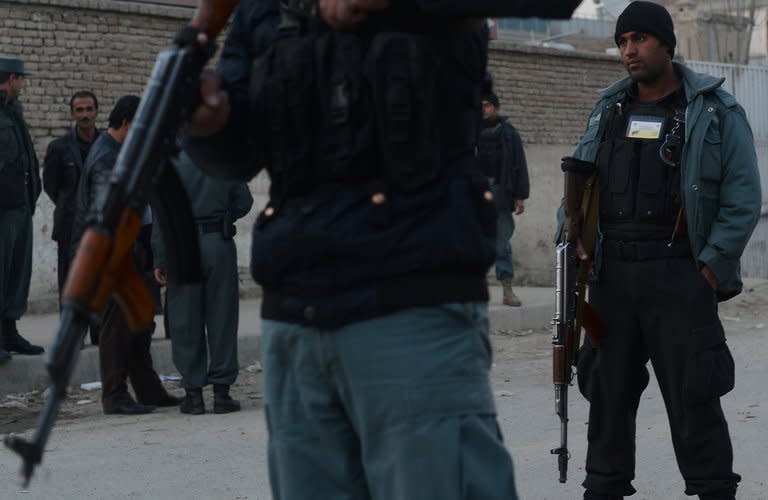 Afghan policemen stand guard near the site of a grenade attack at a spy agency guesthouse in Kabul on December 6. The suicide bomber who tried to assassinate Afghanistan's spy chief detonated a bomb hidden in his underwear, the intelligence agency has said