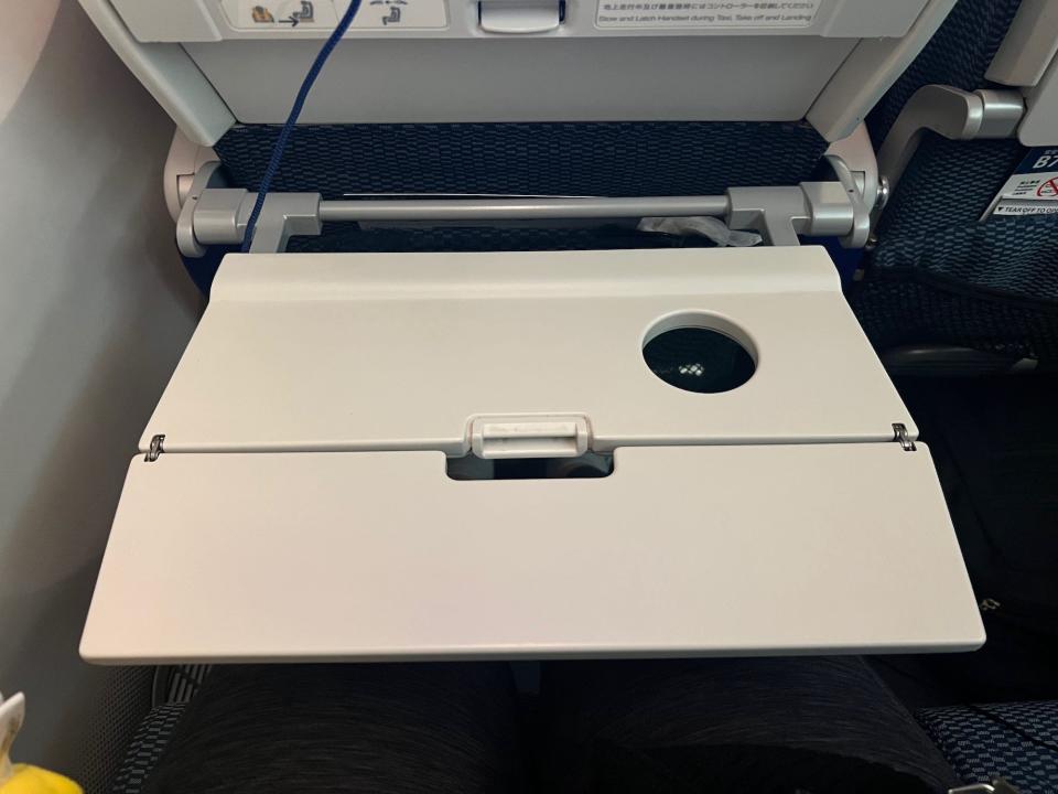 The white tray table unfolded.