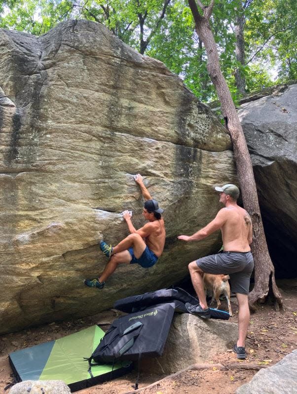 Alexander Rozos rock climbing with his father Michael Rozos in Rumbling Bald near Lake Lure.
