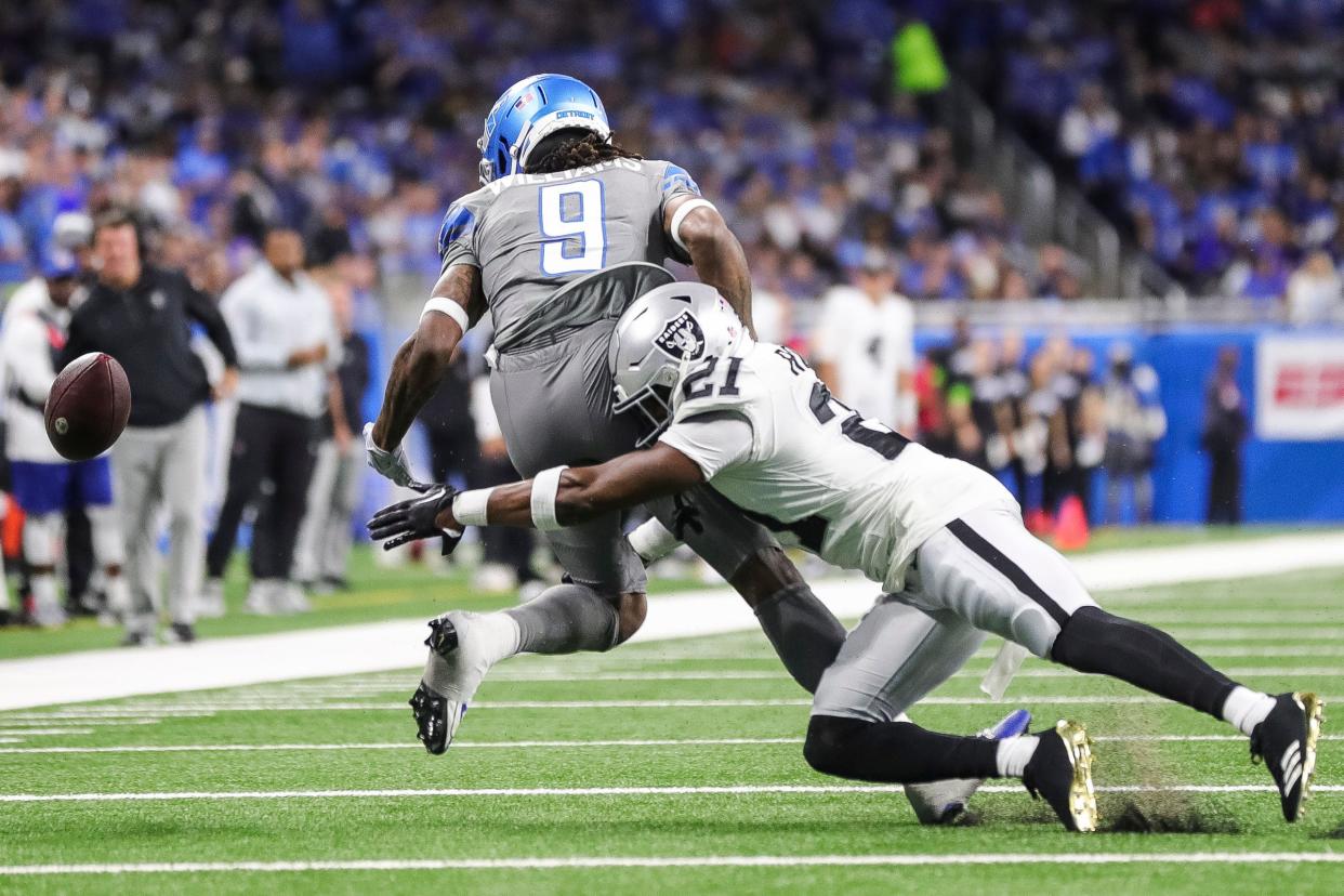 Detroit Lions wide receiver Jameson Williams drops a pass against Las Vegas Raiders cornerback Amik Robertson during the first half at Ford Field in Detroit on Monday, Oct. 30, 2023.