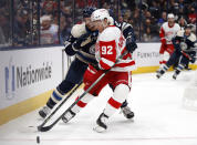 Detroit Red Wings forward Vladislav Namestnikov, right, reaches for the puck in front of Columbus Blue Jackets defenseman Andrew Peeke during the first period of an NHL hockey game in Columbus, Ohio, Monday, Nov. 15, 2021. (AP Photo/Paul Vernon)