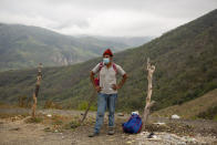 A Honduran migrant waits at a police checkpoint after being detained by police in Zacapa, Guatemala, Tuesday, Jan. 19, 2021. A once large caravan of Honduran migrants that pushed its way into Guatemala last week had dissipated by Tuesday in the face of Guatemalan security forces. (AP Photo/Oliver de Ros)