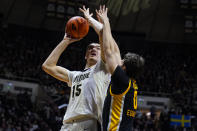 Purdue center Zach Edey (15) shoots over Iowa forward Filip Rebraca (0) during the second half of an NCAA college basketball game in West Lafayette, Ind., Friday, Dec. 3, 2021. (AP Photo/Michael Conroy)