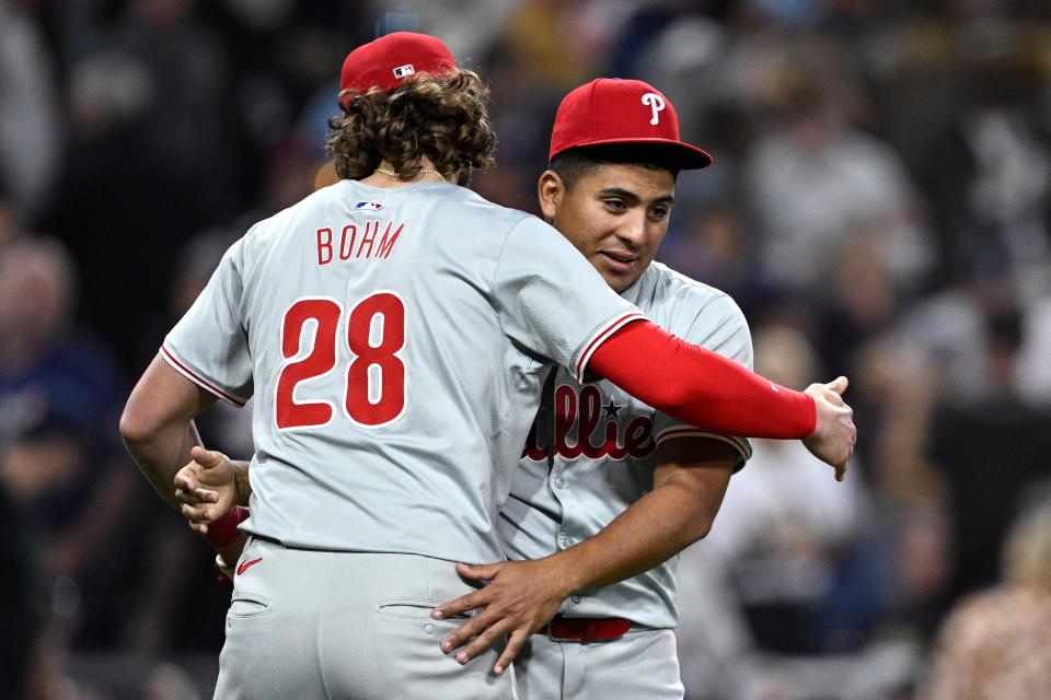 Philadelphia Phillies starting pitcher Ranger Suarez (55) and third baseman Alec Bohm (28) celebrate on the field after defeating the San Diego Padres Saturday at Petco Park in San Diego.