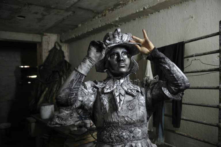 Beatriz Estevez, who studies law at the University of Havana, gets ready to work as a 'living statue' on the streets of Havana