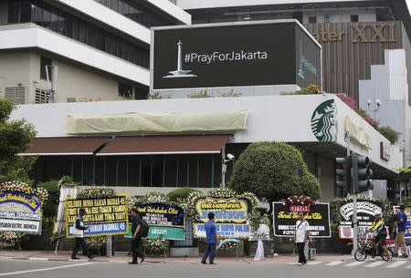 People walk near the site of this week's militant attack in central Jakarta, Indonesia January 16, 2016. REUTERS/Darren Whiteside