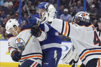 Edmonton Oilers goaltender Mike Smith reaches out to make a save as Caleb Jones defends against Tampa Bay Lightning's Yanni Gourde during the second period of an NHL hockey game Thursday, Feb. 13, 2020, in Tampa, Fla. (AP Photo/Mike Carlson)