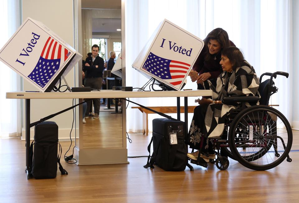 Republican presidential candidate former U.N. Ambassador Nikki Haley (L) helps her mother Raj Kaur Randhawa (R) casts her ballot in the South Carolina Republican primary on February 24, 2024 in Kiawah Island, S.C. Nikki Haley is facing off against former U.S. President Donald Trump in the South Carolina Republican primary. (Photo by Justin Sullivan/Getty Images)