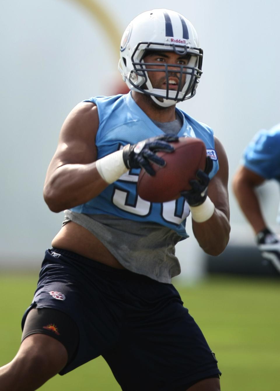 Then-Tennessee Titans linebacker Colin Allred (56) pulls down an interception during practice at Baptist Sports Park in Nashville, Tennessee, on Aug. 16, 2010.