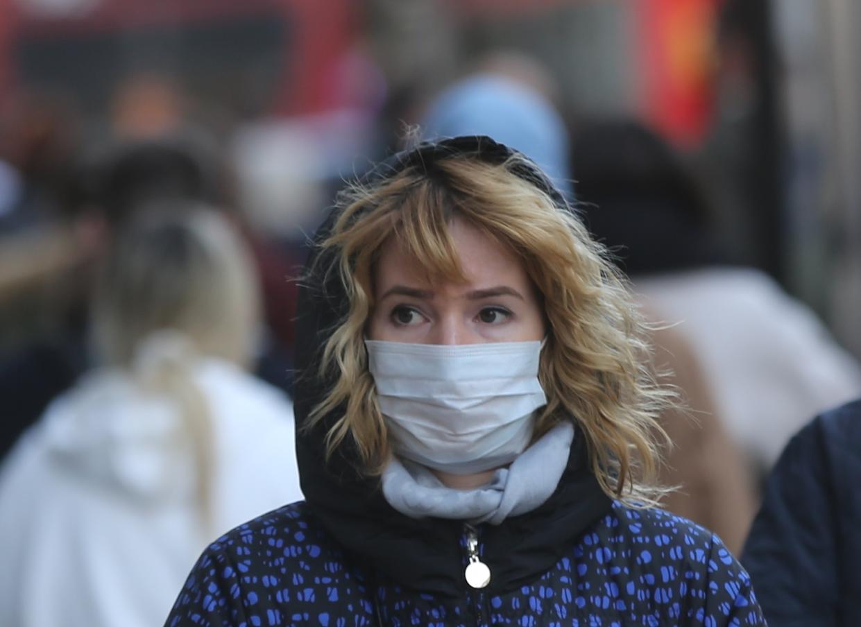 LONDON, UNITED KINGDOM - MARCH 03: A woman wears a mask as a precaution against coronavirus on a street in London, England on March 03, 2020. Eleven more patients in England have tested positive for coronavirus today and the total number of cases reached to 51 in the UK. (Photo by Ilyas Tayfun Salci/Anadolu Agency via Getty Images)