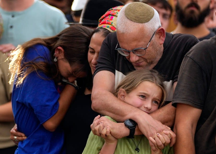 Family members mourn during the funeral of Israeli soldier Shilo Rauchberger at the Mount Herzl cemetery in Jerusalem, Israel, Thursday, Oct. 12, 2023. (AP Photo/Francisco Seco)