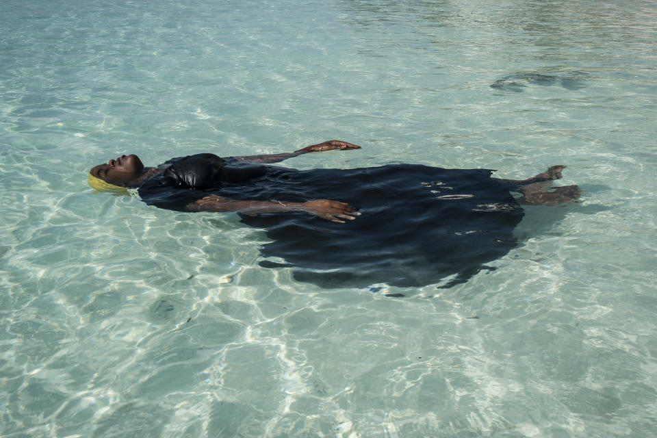 <p>Finding freedom in the water: A young woman learns to float, in the Indian Ocean, off Nungwi, Zanzibar, Nov. 24, 2016.<br>Traditionally, girls in the Zanzibar Archipelago are discouraged from learning how to swim, largely because of the strictures of a conservative Islamic culture and the absence of modest swimwear. But in villages on the northern tip of Zanzibar, the Panje Project (panje translates as ‘big fish’) is providing opportunities for local women and girls to learn swimming skills in full-length swimsuits, so that they can enter the water without compromising their cultural or religious beliefs. (Photo: Anna Boyiazis) </p>