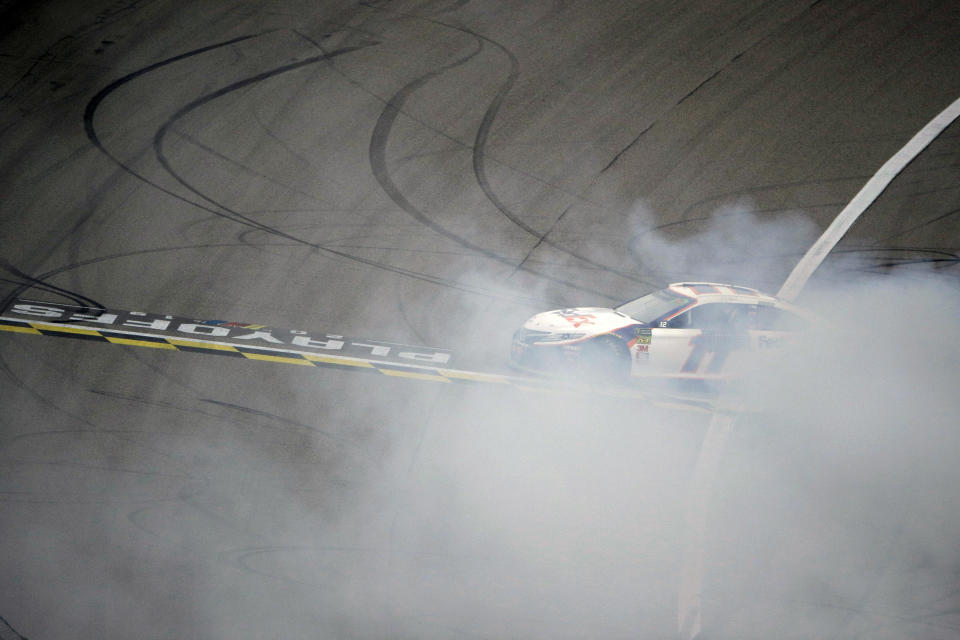 Denny Hamlin does a burnout after winning a NASCAR Cup Series auto race at Kansas Speedway in Kansas City, Kan. Sunday, Oct. 20, 2019. (AP Photo/Charlie Riedel)