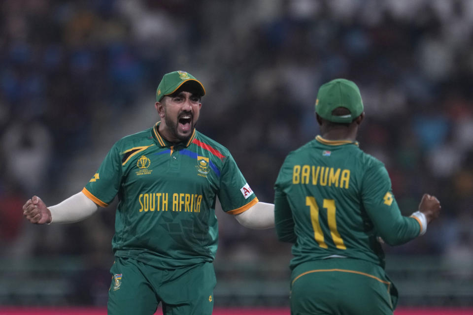 South Africa's Tabraiz Shamshi, left, celebrates with teammate Temba Bavuma the dismissal of Australia's Mitchell Marsh during the ICC Cricket World Cup match between Australia and South Africa in Lucknow, India, Thursday, Oct. 12, 2023. (AP Photo/Altaf Qadri)