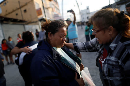 Members of a migrant caravan from Central America and evangelical faithful pray in preparation for an asylum request in the U.S., in Tijuana, Baja California state, Mexico April 28, 2018. REUTERS/Edgard Garrido