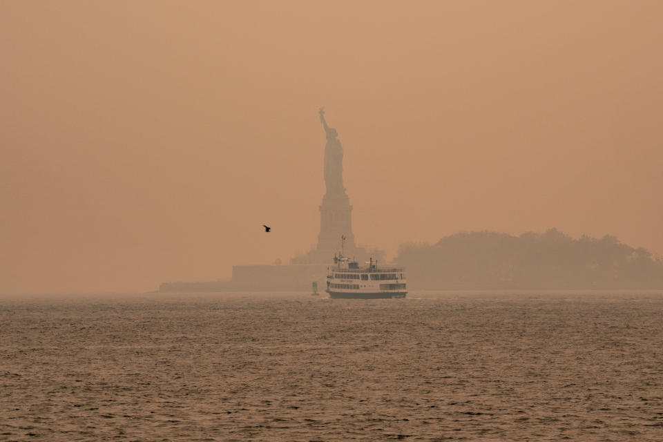 NEW YORK, NEW YORK - JUNE 7:  A smoky haze from wildfires in Canada envelops the Statue of Liberty in Upper Bay on June 7, 2023 in New York City. New York topped the list of most polluted major cities in the world on Tuesday night, as smoke from the fires continues to blanket the East Coast. (Photo by David Dee Delgado/Getty Images)