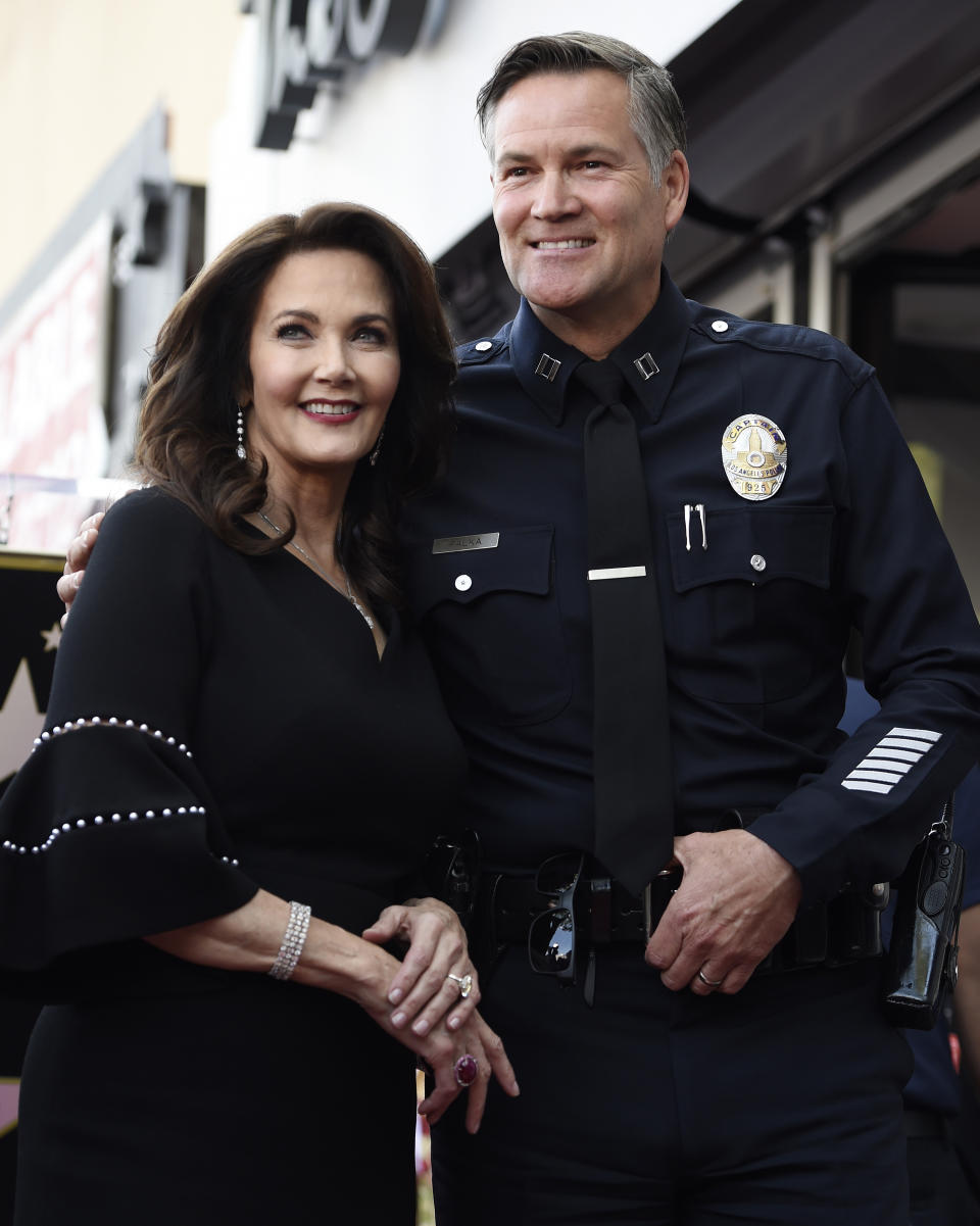 FILE - Actor Lynda Carter, left, poses with former Los Angeles Police Department Captain Cory Palka during a ceremony to award her a star on the Hollywood Walk of Fame, Tuesday, April 3, 2018, in Los Angeles. Palka's ties to Hollywood are under scrutiny after prosecutors say he leaked a sexual assault victim's confidential police report to CBS and its former leader Les Moonves. (AP Photo/Chris Pizzello, File)