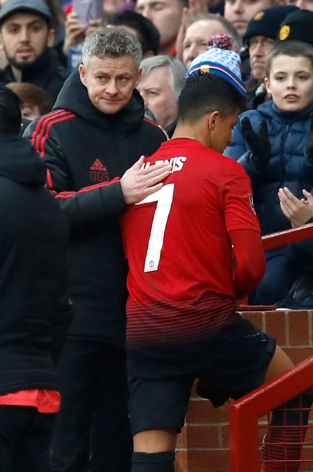 Ole Gunnar Solskjaer, left, consoles Alexis Sanchez after substituting the forward