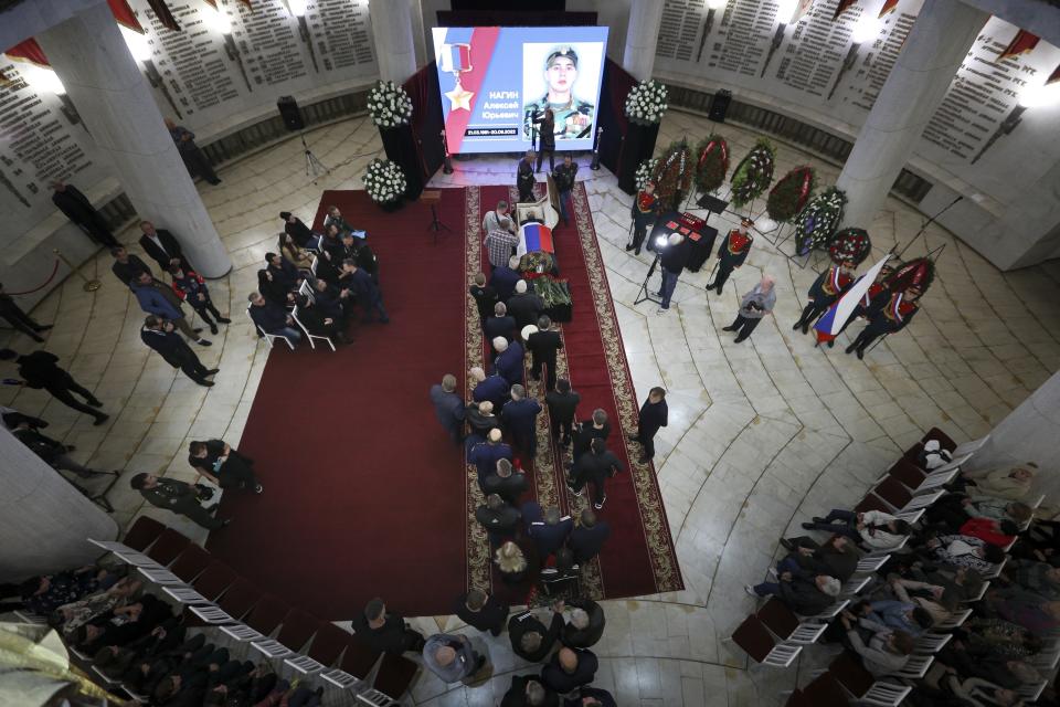 FILE - People attend a mourning ceremony for Alexei Nogin, who was killed in combat in Ukraine, in Volgograd, Russia, on Sept. 24, 2022. Nogin was posthumously awarded with the Hero of Russia medal for fighting in Ukraine. Nearly 50,000 Russian soldiers have died in the war in Ukraine, according to a new statistical analysis. (AP Photo, File)