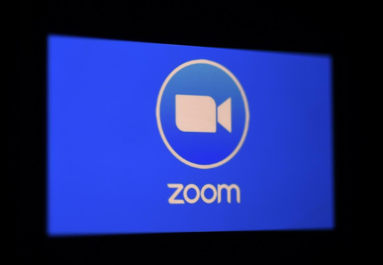 In this photo illustration a Zoom App logo is displayed on a smartphone on March 30, 2020 in Arlington, Virginia. - The Zoom video meeting and chat app has become the wildly popular host to millions of people working and studying from home during the coronavirus outbreak. (Photo by Olivier DOULIERY / AFP) (Photo by OLIVIER DOULIERY/AFP via Getty Images)