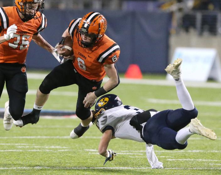 Carson Bey of Versailles gets upended by Ramon Lescano of Kirtland during their DV state championship game at Tom Benson Hall of Fame Stadium on Saturday, Dec. 4, 2021.