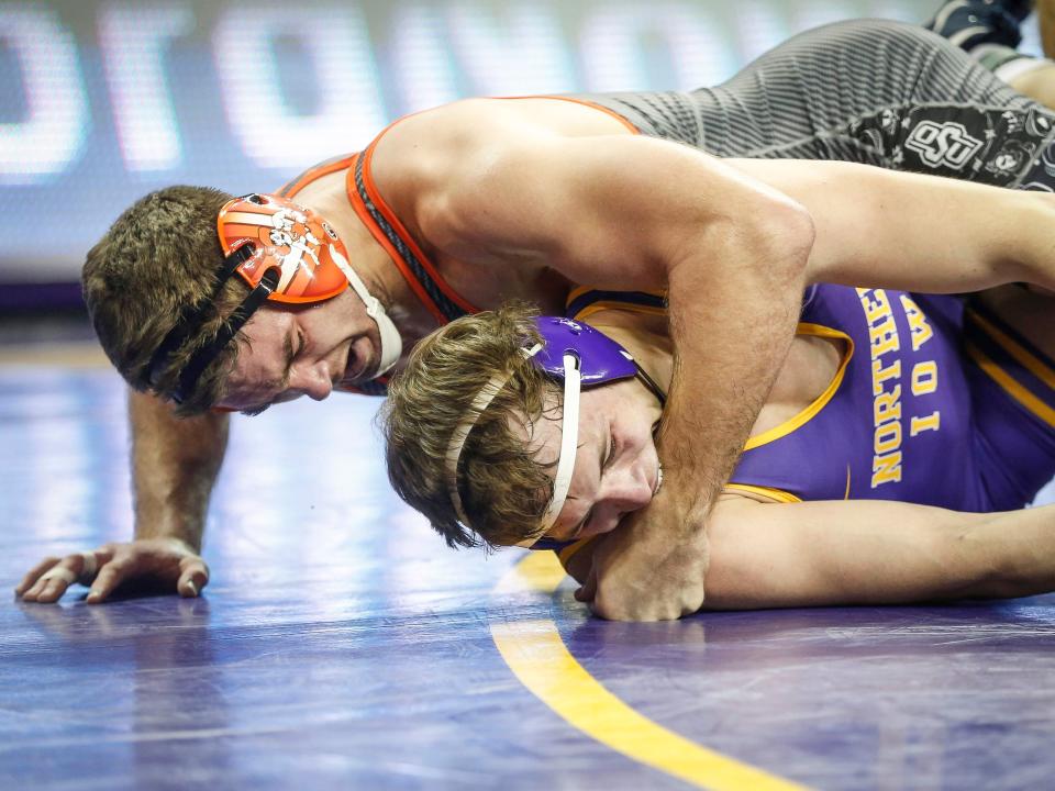 Northern Iowa's Nolan Glaser takes a hard cross face by Oklahoma State's Dakota Geer in their match at 197 pounds on Saturday, Jan. 25, 2020, at the McCleod Center in Cedar Falls.