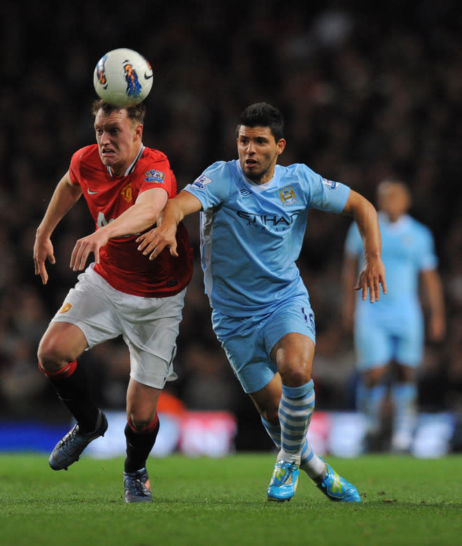 Manchester United's English defender Phil Jones (L) vies for the ball against Manchester City's Argentinian footballer Sergio Aguero during their English Premier League football match at The Etihad stadium in Manchester, north-west England on April 30, 2012. AFP PHOTO/ANDREW YATES RESTRICTED TO EDITORIAL USE. No use with unauthorized audio, video, data, fixture lists, club/league logos or “live” services. Online in-match use limited to 45 images, no video emulation. No use in betting, games or single club/league/player publications.ANDREW YATES/AFP/GettyImages