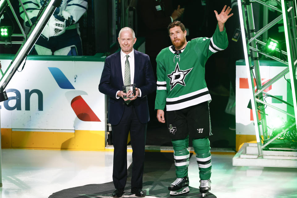 Dallas Stars general manager Jim Nill, left, presents Joe Pavelski with a memento after Pavelski reached 1,000 points in his NHL career, before the team's hockey game against the Toronto Maple Leafs, Thursday, Oct. 26, 2023, in Dallas. (AP Photo/Brandon Wade)