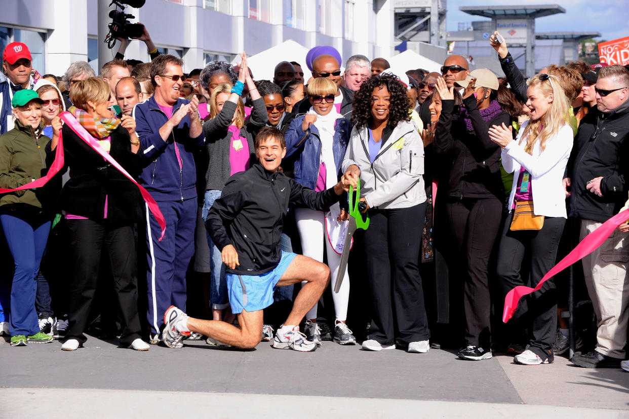 NEW YORK - MAY 09:  Media personality and physician Dr. Mehmet Oz (left center) and media personality Oprah Winfrey (right center) cut the ribbon to signal the start of the 