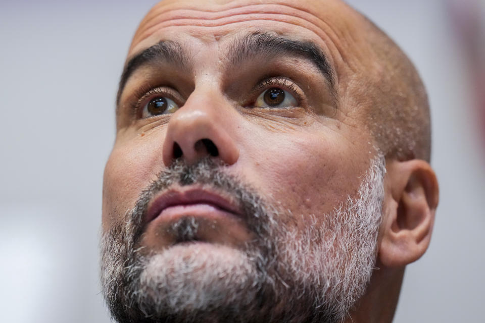 Manchester City's head coach Pep Guardiola attends a press conference at the King Abdullah Sports City Stadium in Jeddah, Saudi Arabia, Monday, Dec. 18, 2023. Urawa Reds will play against Manchester city during the semifinal soccer match during the Club World Cup on Tuesday Dec. 19.(AP Photo/Manu Fernandez)