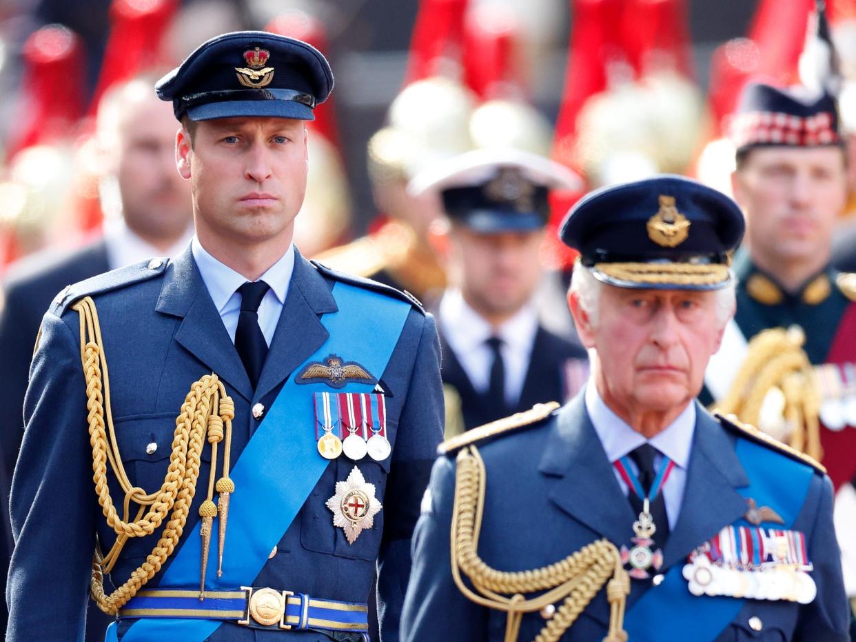 Prince William, Prince of Wales and King Charles III walk behind Queen Elizabeth II's coffin as it is transported on a gun carriage to Westminster Hall.