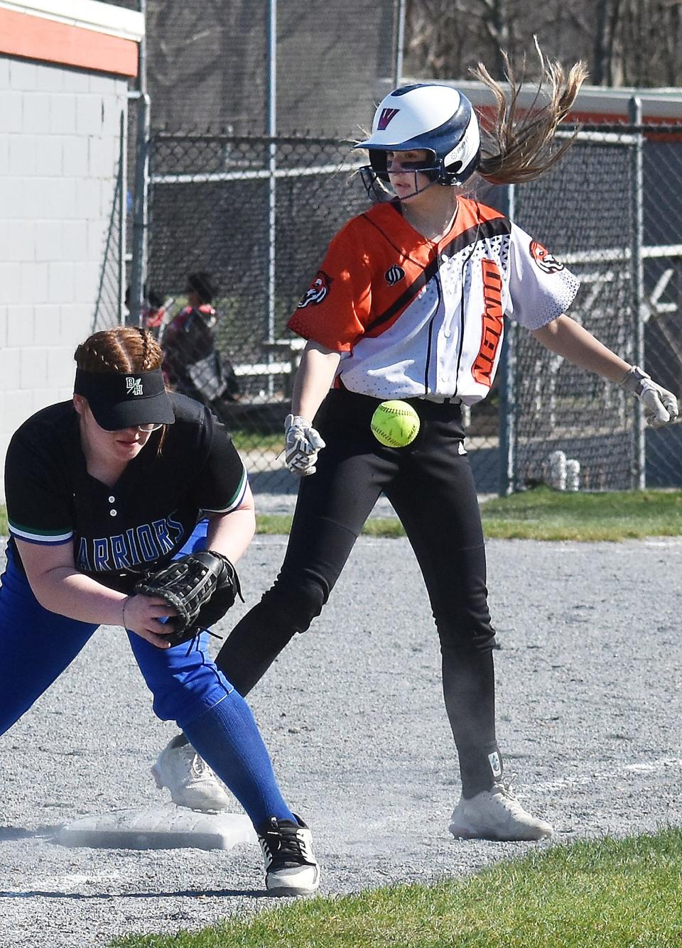 Diman's Courtney Boies is safe at third base as Blue Hills' Kailey Hixon gets the throw late.