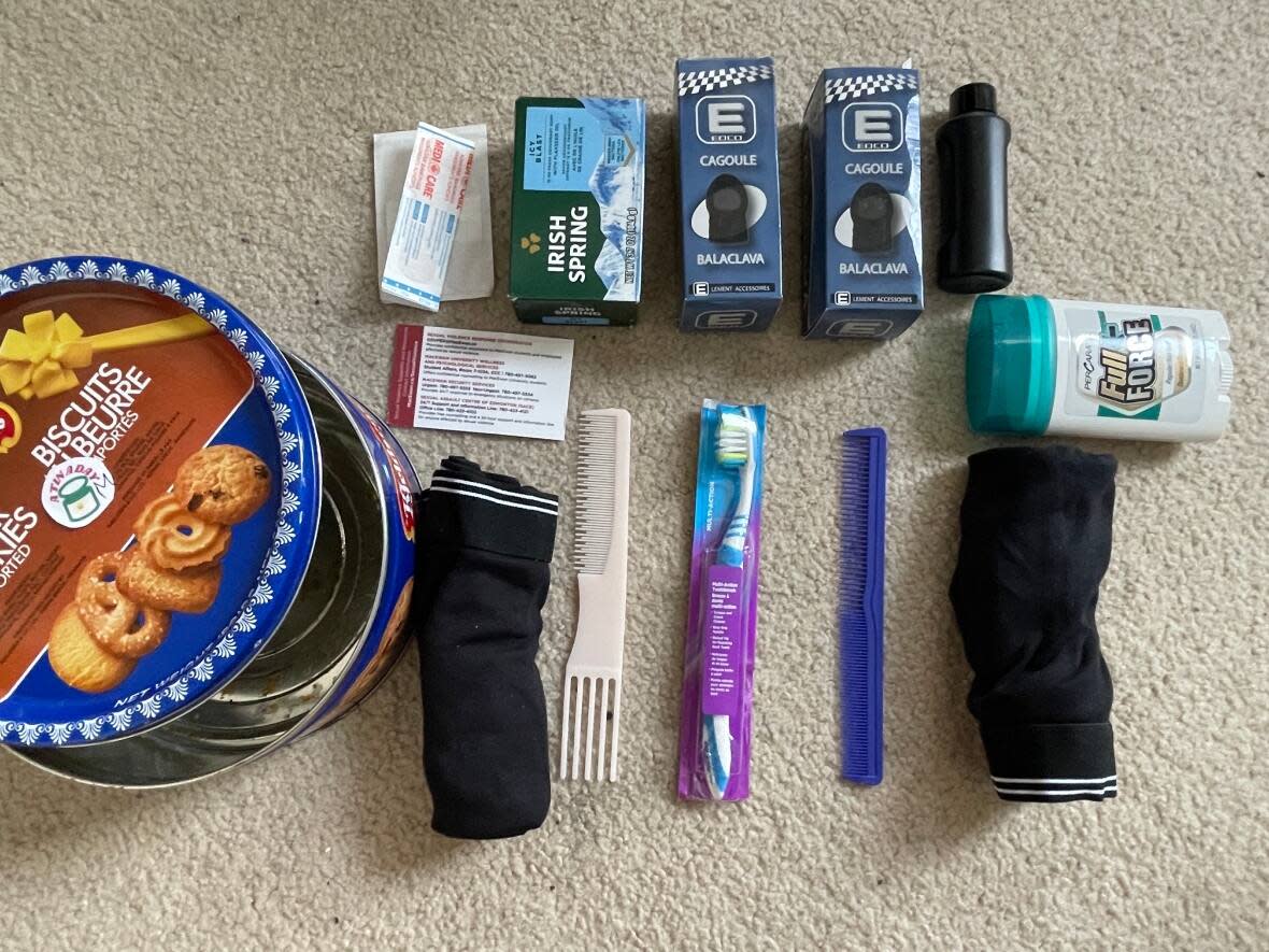 In a project she calls A Tin A Day, social work student Christine Wincentaylo packs empty cookie and coffee tins with self-care items and hands them out to people living on the street. (Emily Fitzpatrick/CBC - image credit)