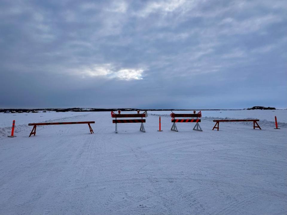 Barricades block access to the Yellowknife-Dettah ice road at the school draw entrance.