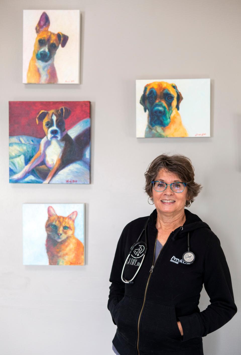 Dr. Kathy Bates, of North Fork Animal Clinic, stands by some of the portraits of animals she has painted, which are animals she has treated, inside North Fork Animal Clinic on Nov, 10, 2022 in Chillicothe, Ohio.