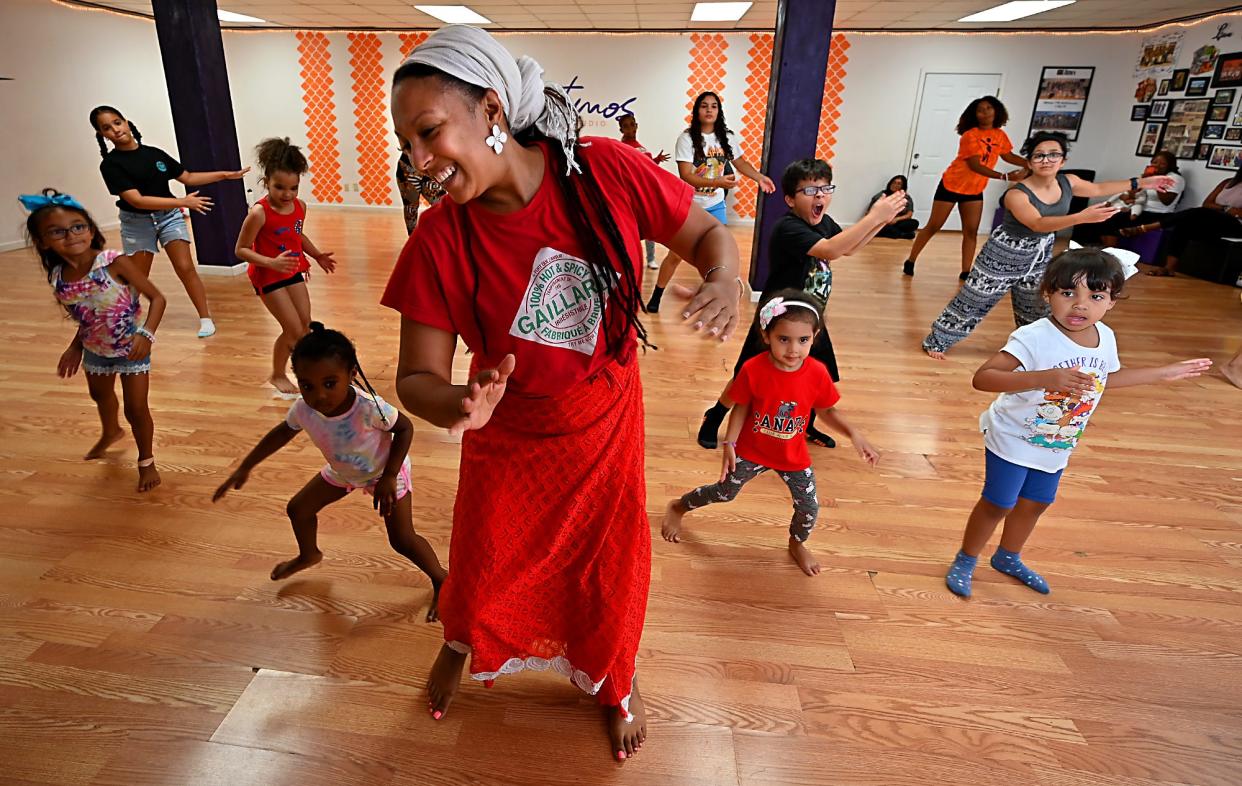 Lila Sylla, accompanied by musicians from Worcester-based Crocodile River Music, teaches students at Ritmos Dance Studio the West African dance, dansa, during a summer workshop Wednesday evening.