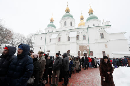 People queue to attend the demonstration of Tomos, a decree granting the Orthodox Church of Ukraine independence, at the compound of the Saint Sophia's Cathedral in Kiev, Ukraine January 7, 2019. REUTERS/Valentyn Ogirenko