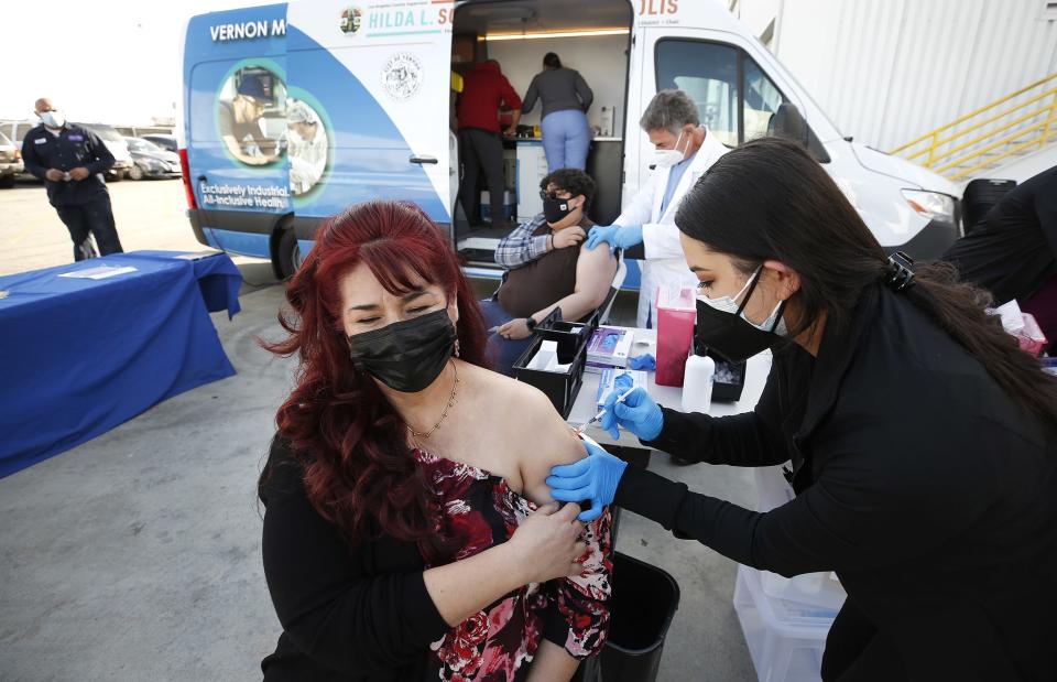 The city of Vernon demonstrates the use of special refrigeration to store Pfizer COVID-19 vaccine as they city is using a van to operate a mobile clinic and provide vaccination to frontline workers at various food and industrial plants in the city. (Al Seib / Los Angeles Times via Getty Images file)